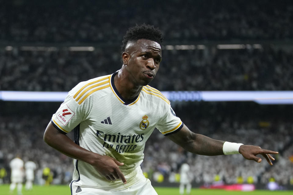 Real Madrid's Vinicius Junior celebrates after scoring his side's opening goal during the Spanish La Liga soccer match between Real Madrid and Barcelona at the Santiago Bernabeu stadium in Madrid, Spain, Sunday, April 21, 2024. (AP Photo/Manu Fernandez)