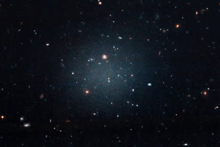 The galaxy named NGC 1052-DF2, a large fuzzy-looking galaxy so diffused that astronomers call it a 'see-through' galaxy because its missing most, if not all of its dark matter, is shown in this photo obtained from NASA on March 28, 2018.    NASA, ESA, and P. van Dokkum (Yale University)/Handout via REUTERS