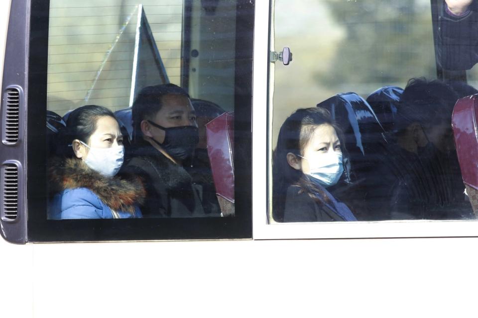 People wear masks on a bus in Pyongyang.