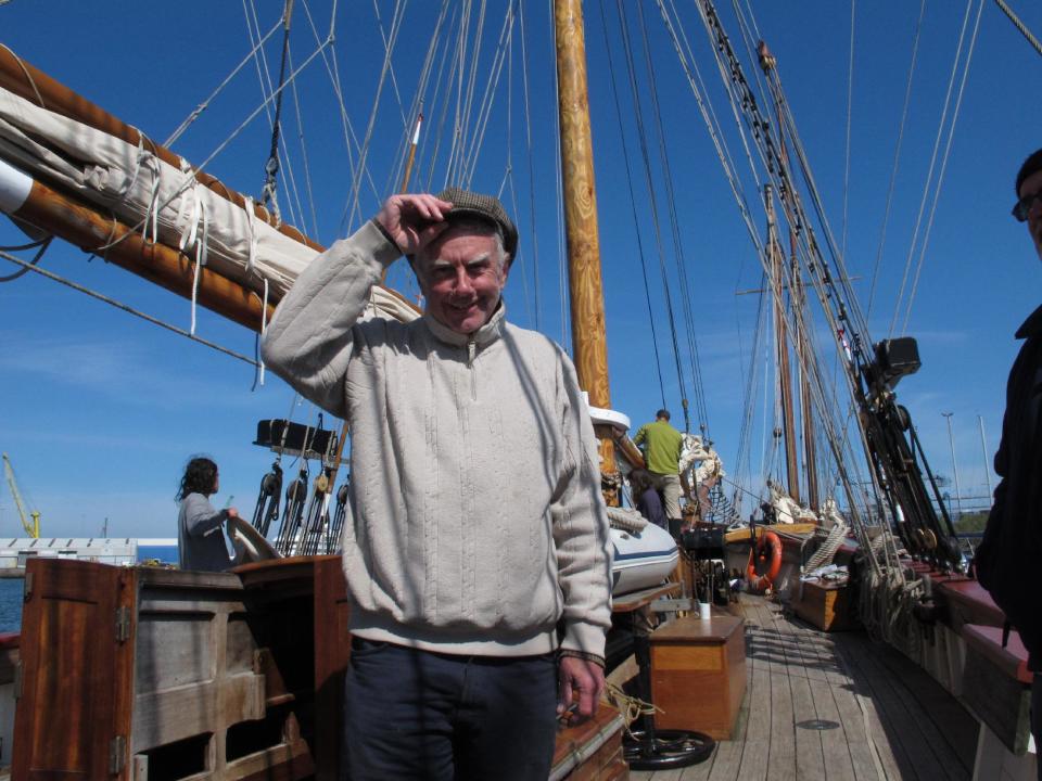 This May 17, 2013 photo shows crew member Brian Copeland of Liverpool, England, tipping his hat as his tall ship docks in Dublin port. The ship was participating in The Gathering, a yearlong tourism initiative to boost the country's economy by luring its diaspora home. His ship and others taking part in the event were replicas of vessels that once carried millions of emigrants away from Ireland to seek their fortune elsewhere. (AP Photo/Helen O'Neill)