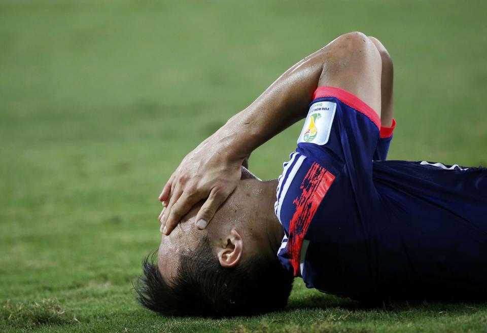 Japan's Shinji Okazaki reacts on the ground during their 2014 World Cup Group C soccer match against Colombia at the Pantanal arena in Cuiaba June 24, 2014. REUTERS/Jorge Silva (BRAZIL - Tags: SOCCER SPORT WORLD CUP)