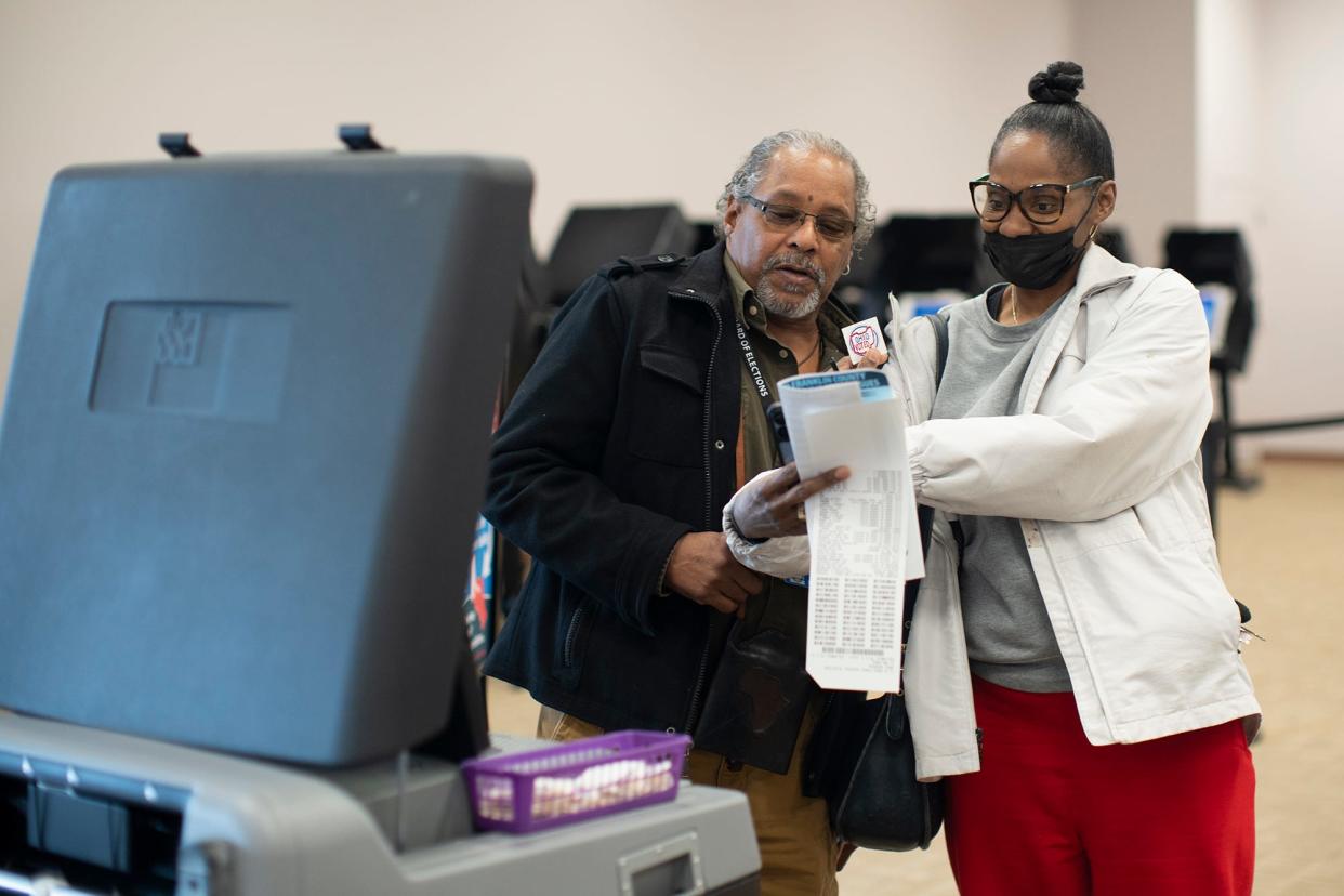 Daphney Brown, of Columbus, takes a selfie with poll worker Virgil Rhea, during early voting at the Franklin County Board of Elections. Courtney Hergesheimer/ Columbus Dispatch