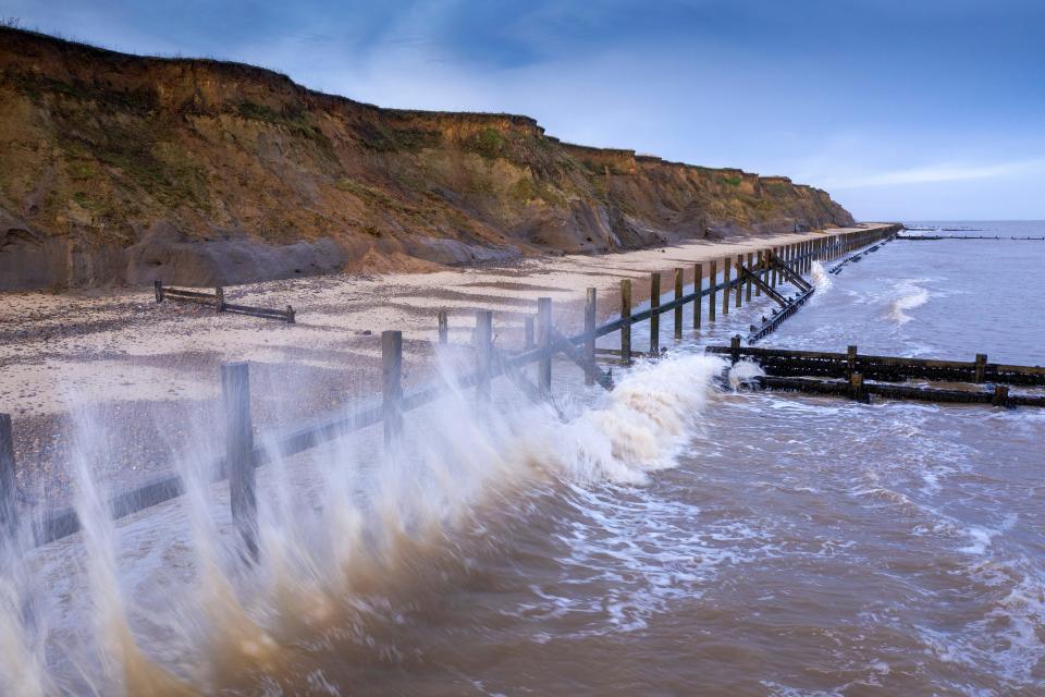 Waves crash against destroyed sea defences in the coastal village of Happisburgh