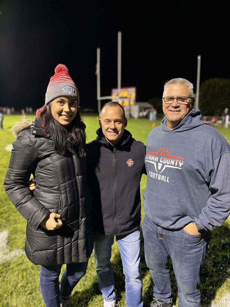 Stark County principal Megan McGann, left, superintendent Brett Elliott, middle and athletics director Roland Brown pose for a photo between the third and fourth quarters of SC's 28-20 victory over Monmouth United on Friday, Oct. 20. The trio all have Peoria Public School ties, specifically Richwoods.