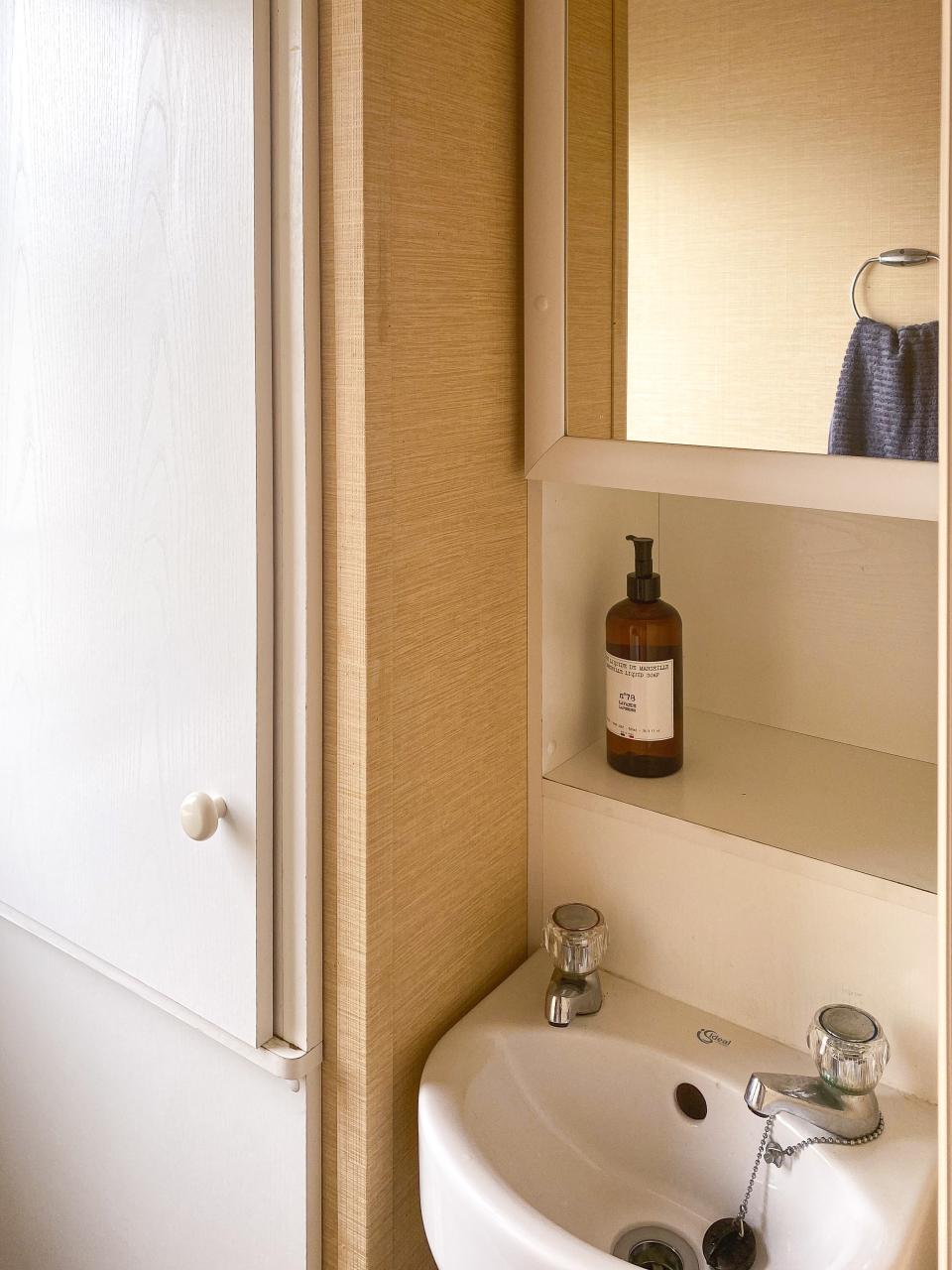 BEFORE: The second bathroom contains only a small washbasin and a toilet but felt equally gloomy before the renovation.