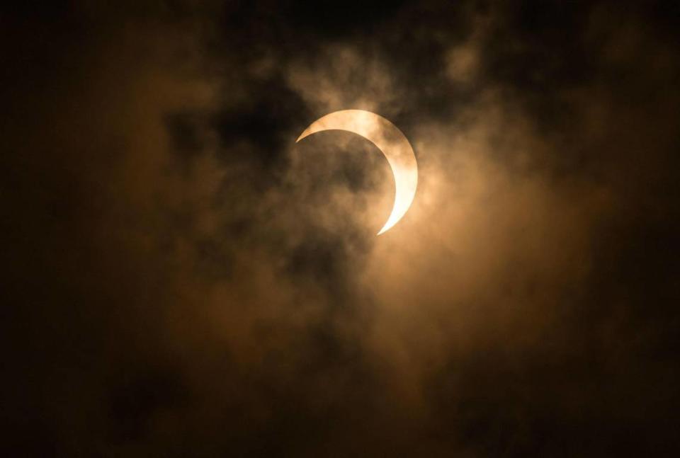 A rare annular solar eclipse is visible leaving its peak nearest “totality” on Oct. 14, 2023, as sky gazers gathered an event outside Sacramento State’s planetarium. The partial eclipse reached about 80% in the Sacramento region, and was intermittently covered by drifting clouds.