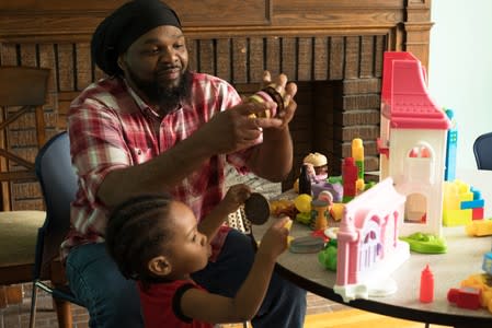 Monae Davis plays with a grandchild after an interview in Buffalo