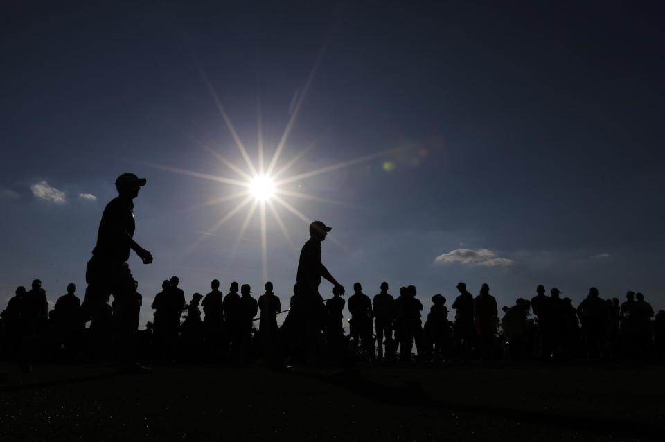 Jordan Spieth, left, walks with Adam Scott, of Australia, on the 18th fairway during the third round of the Masters golf tournament Saturday, April 12, 2014, in Augusta, Ga. (AP Photo/David J. Phillip)