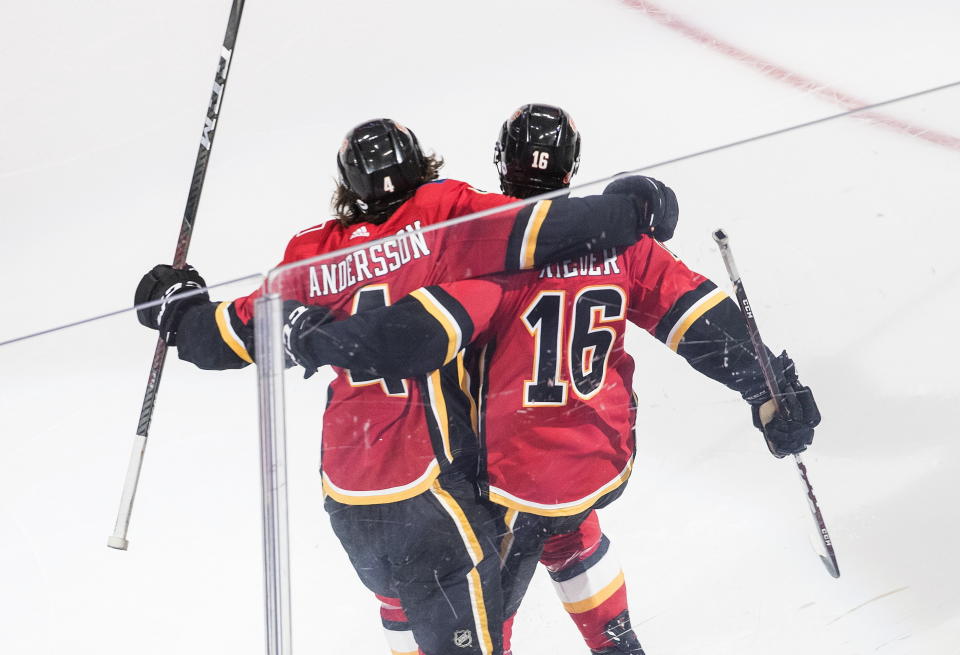 Calgary Flames' Rasmus Andersson (4) and Tobias Rieder (16) celebrate a goal against the Winnipeg Jets during the second period of an NHL hockey playoff game Saturday, Aug. 1, 2020 in Edmonton, Alberta. (Jason Franson/The Canadian Press via AP)