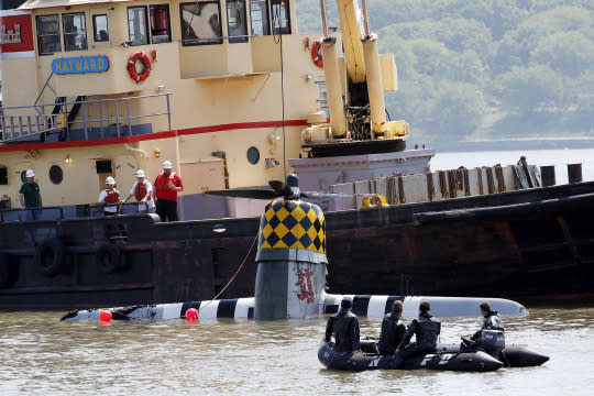 <p>Officials remove a plane from the Hudson River a day after it crashed, Saturday, May 28, 2016, in North Bergen, N.J. The World War II vintage P-47 Thunderbolt aircraft crashed into the river Friday, May 27. (AP Photo/Julio Cortez) </p>