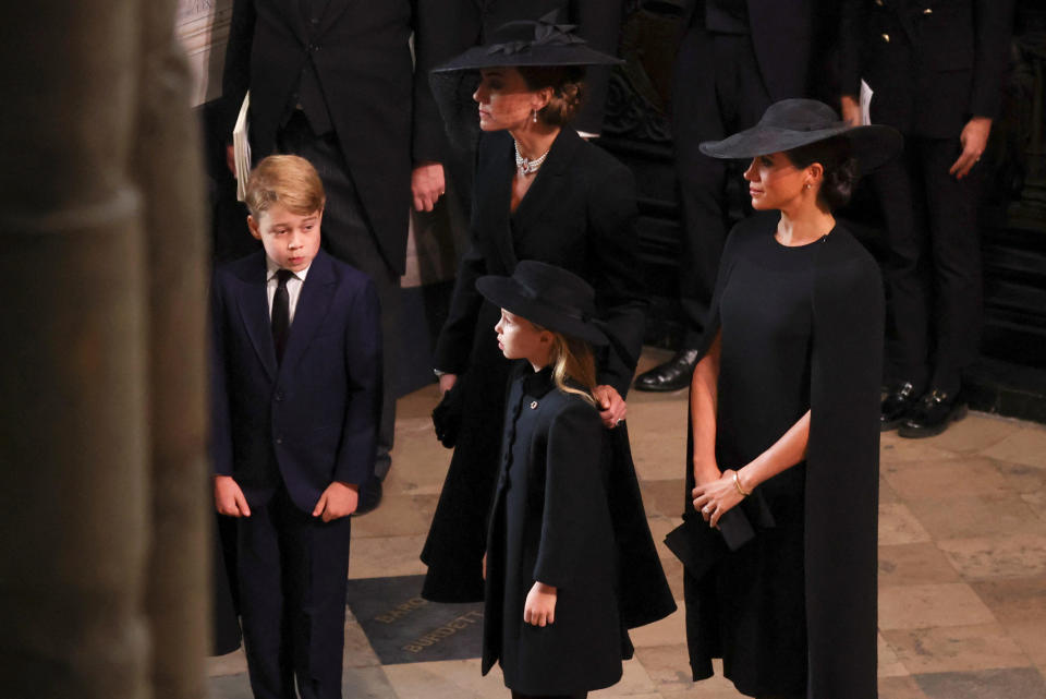LONDON, ENGLAND – SEPTEMBER 19: Catherine, Princess of Wales, Princess Charlotte of Wales, Prince George of Wales and Meghan, Duchess of Sussex attend Westminster Abbey for the State Funeral of Queen Elizabeth II on September 19, 2022 in London, England. Elizabeth Alexandra Mary Windsor was born in Bruton Street, Mayfair, London on 21 April 1926. She married Prince Philip in 1947 and ascended the throne of the United Kingdom and Commonwealth on 6 February 1952 after the death of her Father, King George VI. Queen Elizabeth II died at Balmoral Castle in Scotland on September 8, 2022, and is succeeded by her eldest son, King Charles III. (Photo by Phil Noble – WPA Pool/Getty Images)