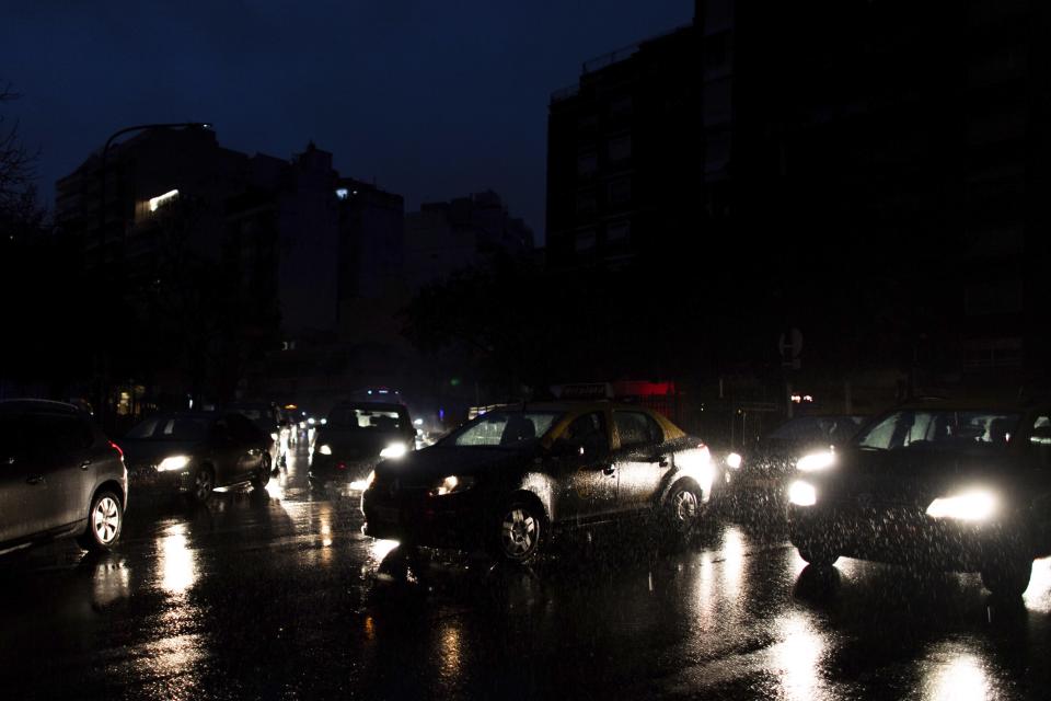 Cars drive through an unlit street during a blackout in Buenos Aires, Argentina, Sunday, June 16, 2019. A massive blackout left tens of millions of people without electricity in Argentina, Uruguay and Paraguay on Sunday in what the Argentine president called an “unprecedented” failure in the countries’ power grid. (AP Photo/Tomas F. Cuesta)