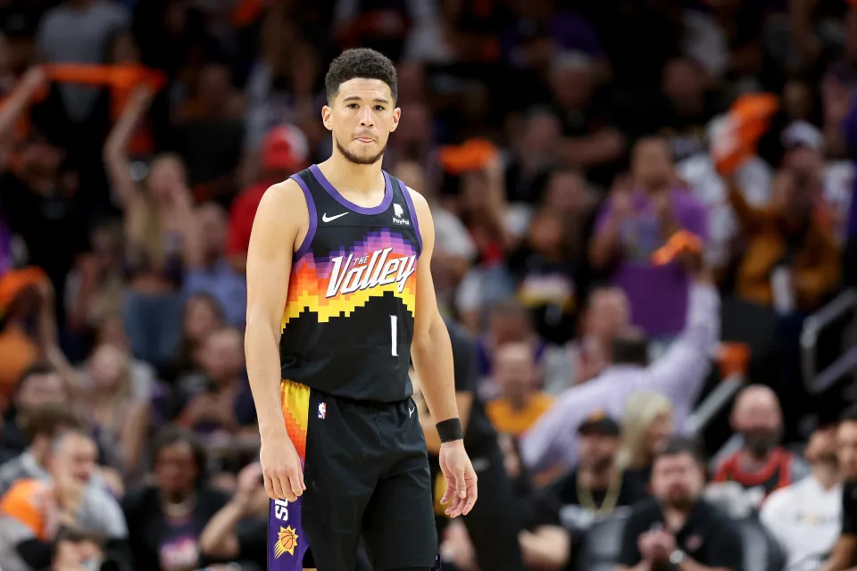 PHOENIX, ARIZONA - APRIL 19: Devin Booker #1 of the Phoenix Suns looks on during the first half of Game Two of the Western Conference First Round NBA Playoffs at Footprint Center on April 19, 2022 in Phoenix, Arizona. NOTE TO USER: User expressly acknowledges and agrees that, by downloading and or using this photograph, User is consenting to the terms and conditions of the Getty Images License Agreement. (Photo by Christian Petersen/Getty Images)