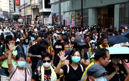 Anti-government protesters wearing masks attend a protest in Causeway Bay district, in Hong Kong