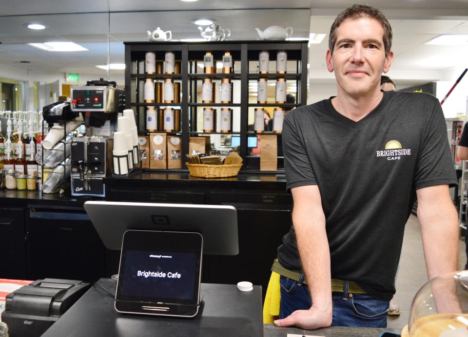 Abe Carney, one of the co-owners of Brightside Cafe, stands behind the counter on Feb. 2, 2024, the first day the cafe opened its doors in Fountain Square in downtown Bloomington.