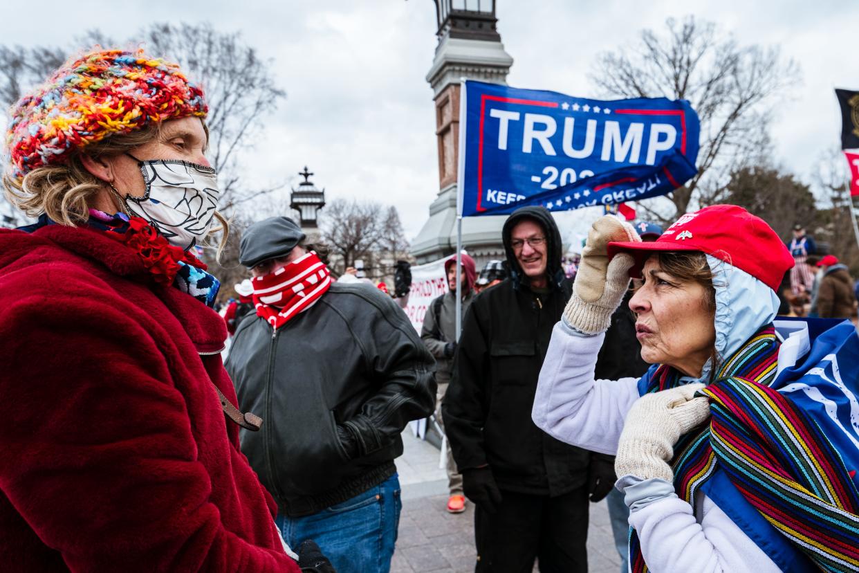 A pair of counter-protesters are confronted by pro-Trump protesters in front of Capitol Building on January 6, 2021 in Washington, DC. A pro-Trump mob stormed the Capitol, breaking windows and clashing with police officers.