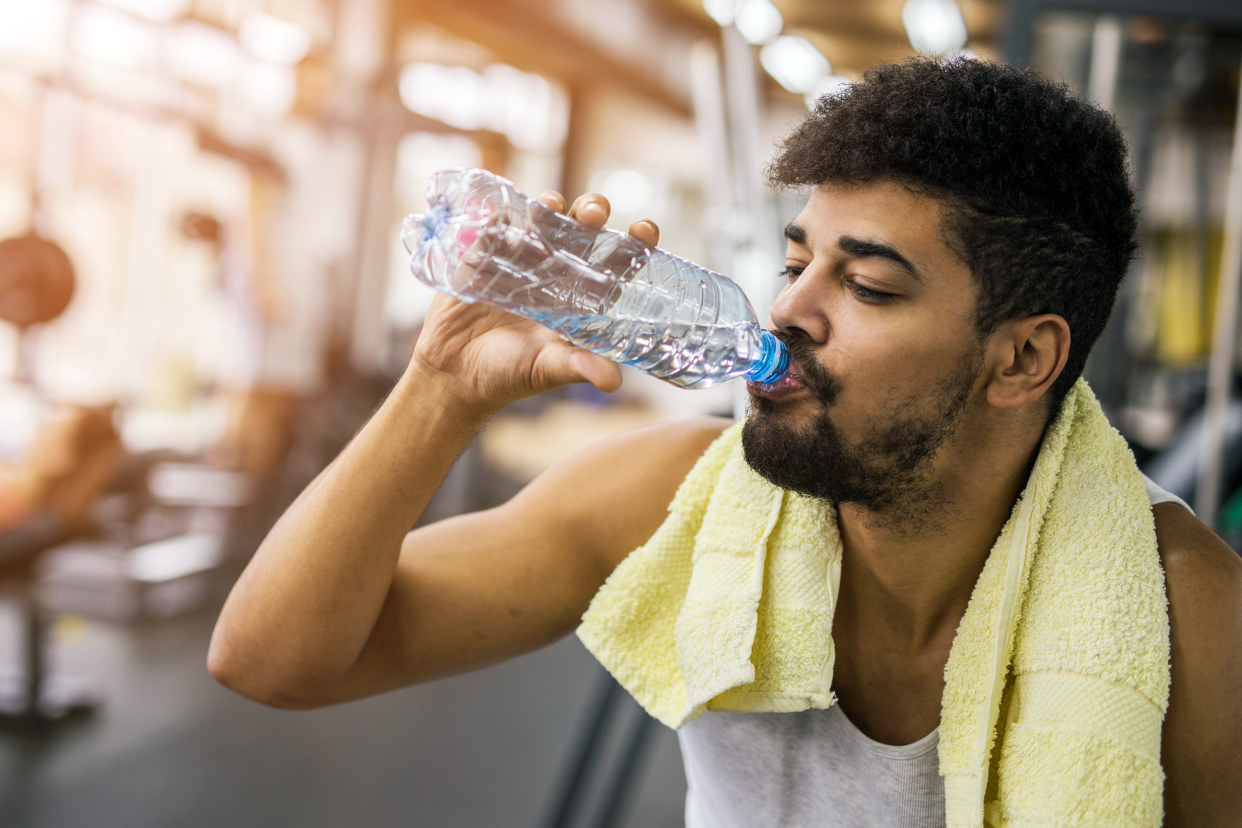 Man drinking water in a gym