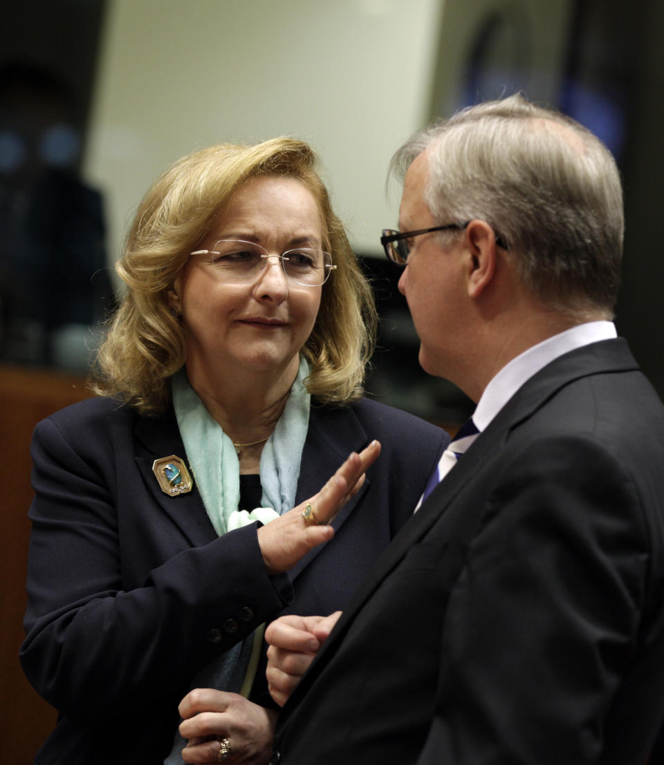 Austria's Finance Minister Maria Fekter, left, speaks with European Commissioner for the Economy Olli Rehn during a meeting of EU finance ministers at the EU Council building in Brussels on Tuesday, March 13, 2012. The decision to give Spain some more leeway on cutting this year's deficit is already triggering demands for more fiscal leniency for other European countries. Finance ministers from the eurozone said Monday that Spain will be allowed to run a deficit of 5.3 percent of gross domestic product this year, above the original 4.4 percent target. (AP Photo/Virginia Mayo)