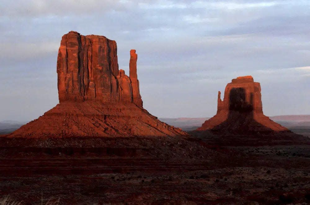Sunset at Monument Valley cast "mitten-shaped" shadows on red rocks.