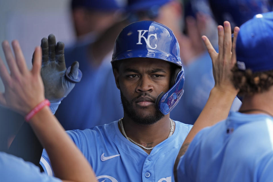 Kansas City Royals' Maikel Garcia celebrates in the dugout after scoring on a sacrifice fly hit by Vinnie Pasquantino during the fourth inning of a baseball game against the San Diego Padres Sunday, June 2, 2024, in Kansas City, Mo. (AP Photo/Charlie Riedel)