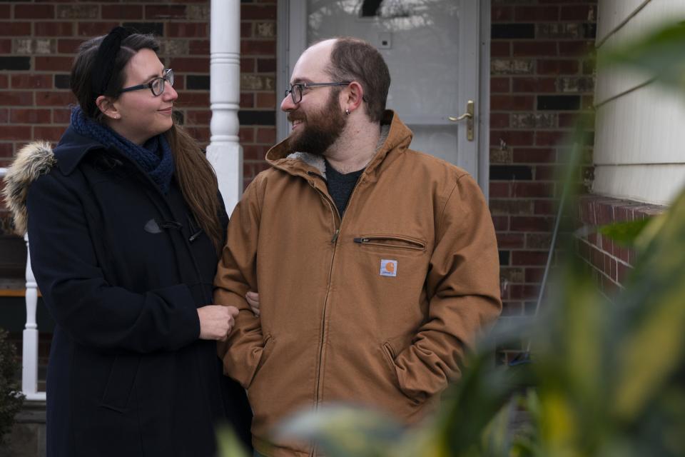 Ethan Miller, right, and Rachel Mandelbaum pose for a portrait outside their home in Silver Spring, Md., Friday, Jan., 21, 2022. Tax filing season starts Monday and people can expect the task to be more cumbersome than usual this year thanks to an overloaded and understaffed IRS workforce and new complications from pandemic-related programs. (AP Photo/Jacquelyn Martin)