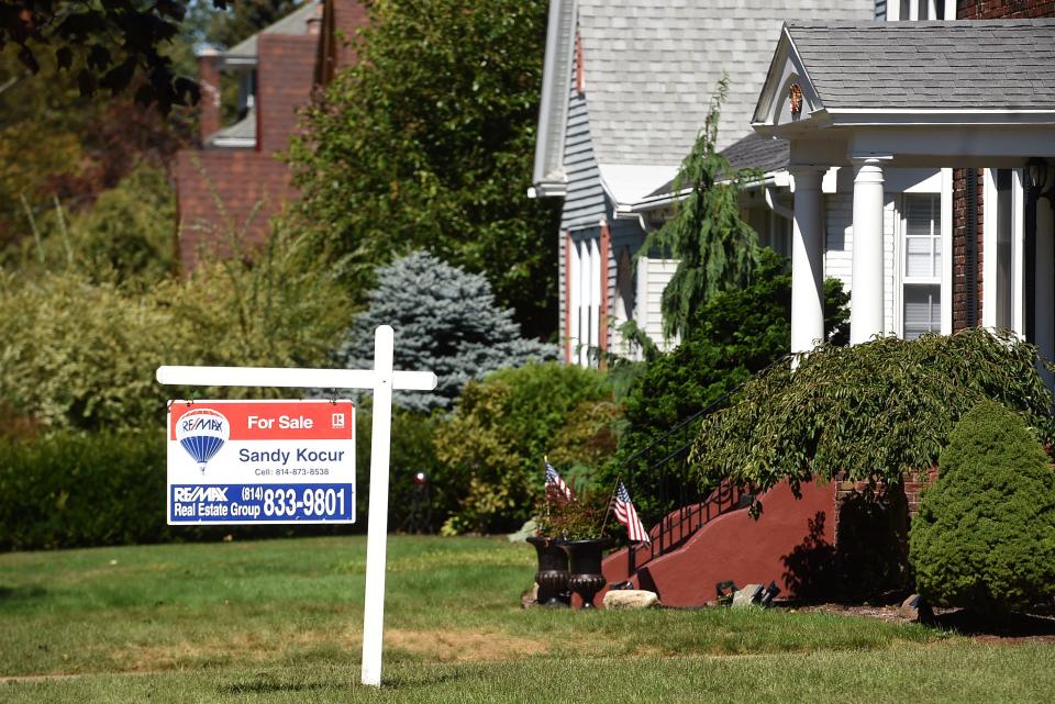 In this file photo, a sign advertising the sale of a home is shown Sept. 16, 2021, near West Sixth Street and Kahkwa Boulevard in Erie.