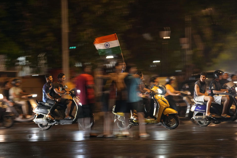 Cricket fans celebrate in Mumbai, India, Saturday, June 29, 2024, after India defeated South Africa in the ICC T20 World Cup final match in Barbados. (AP Photo/Rajanish Kakade)