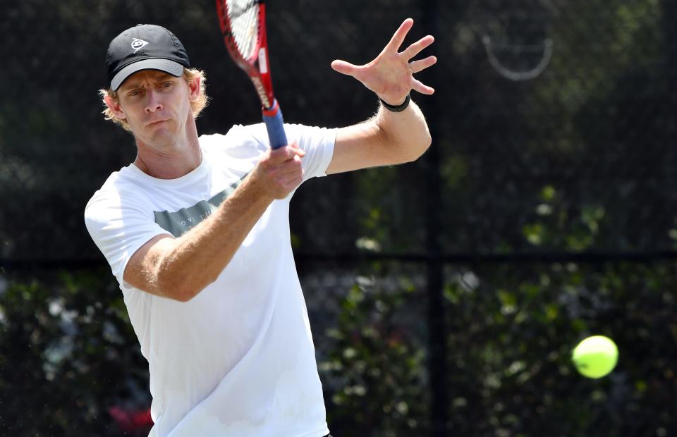 Current ATP pro Kevin Anderson returns a volley during a benefit to raise money for First Serve USA.