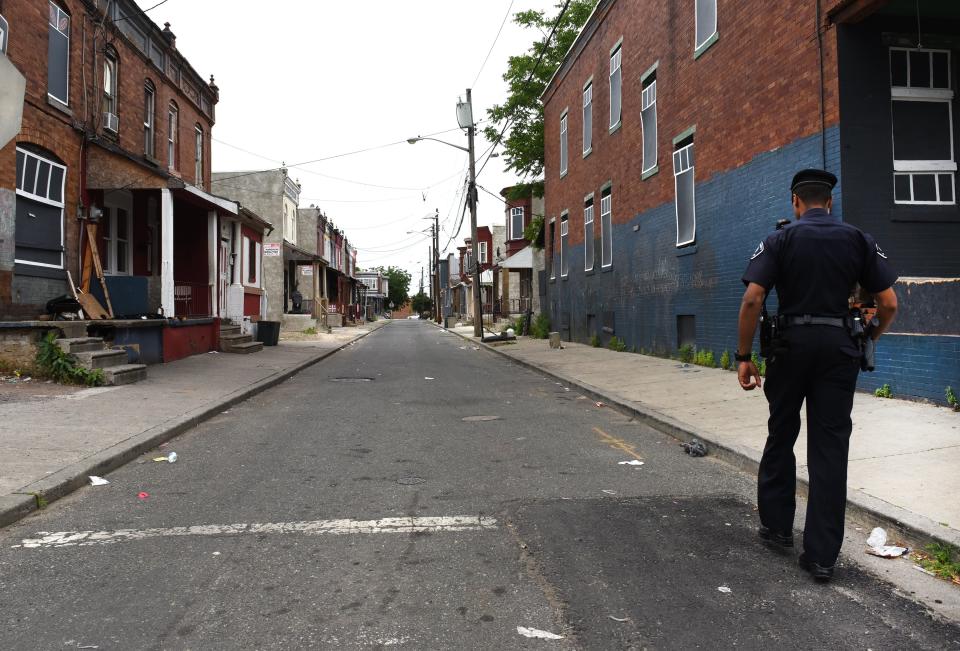 Camden County Police Department officer Jose Delvalle is seen on foot patrol in Camden, New Jersey, on May 24, 2017. In 2013  the city of Camden, New Jersey, dissolved its police force, replacing it with a new county-run department where they are turning around a city that had one of the highest crime rates in the country. Police reform and falling crime statistics turned Camden into a poster child for better policing.  / AFP PHOTO / TIMOTHY A. CLARY / TO GO WITH AFP STORY by Jennie MATTHEW,  US-politics-police          (Photo credit should read TIMOTHY A. CLARY/AFP via Getty Images)