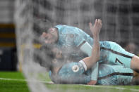 Liverpool's Mohamed Salah, down, celebrates with Liverpool's Curtis Jones after scoring his side's fourth goal during the English Premier League soccer match between Manchester United and Liverpool, at the Old Trafford stadium in Manchester, England, Thursday, May 13, 2021. (Peter Powell/Pool via AP)