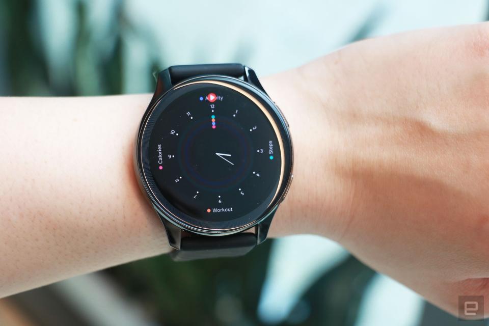 <p>OnePlus Watch review photos. OnePlus Watch on a wrist showing a faux analog watch face with markers for progress on Calories, Steps and Workout.</p>
