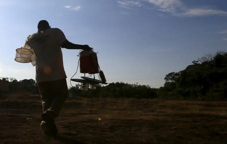 A researcher from the Uganda Virus Research Institute (UVRI) carries insect traps at the Zika Forest in Entebbe, south of Uganda's capital Kampala March 2, 2016.REUTERS/James Akena