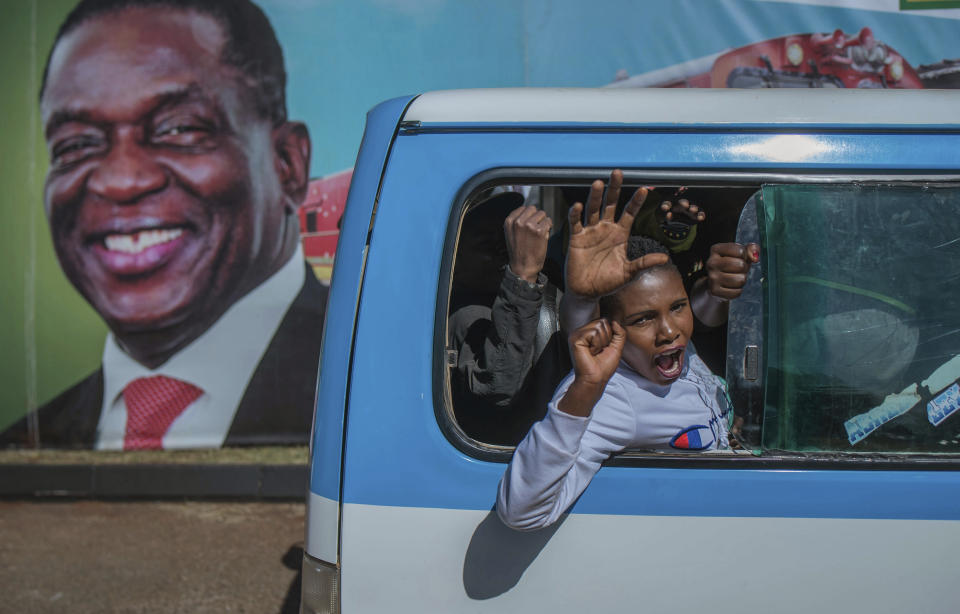 Ruling ZANU PF supporters arrive at an election rally in Harare, Zimbabwe on Saturday July 28, 2018. Zimbabwean President Emmerson Mnangagwa, shown on poster at left, and main challenger Nelson Chamisa are set to hold final campaign rallies ahead of Monday's election in a country seeking to move past decades of economic and political paralysis. (AP Photo)