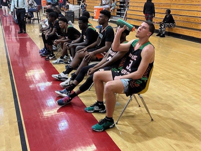 Atlantic junior guard Lincoln Graf (right) takes a water break during Wednesday night's game.