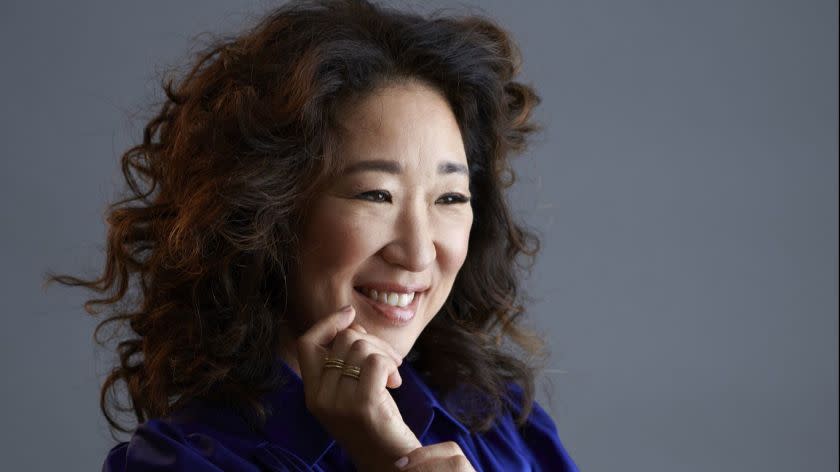 Actress Sandra Oh pulled double duty Sunday night as a Golden Globes co-host and an award recipient.