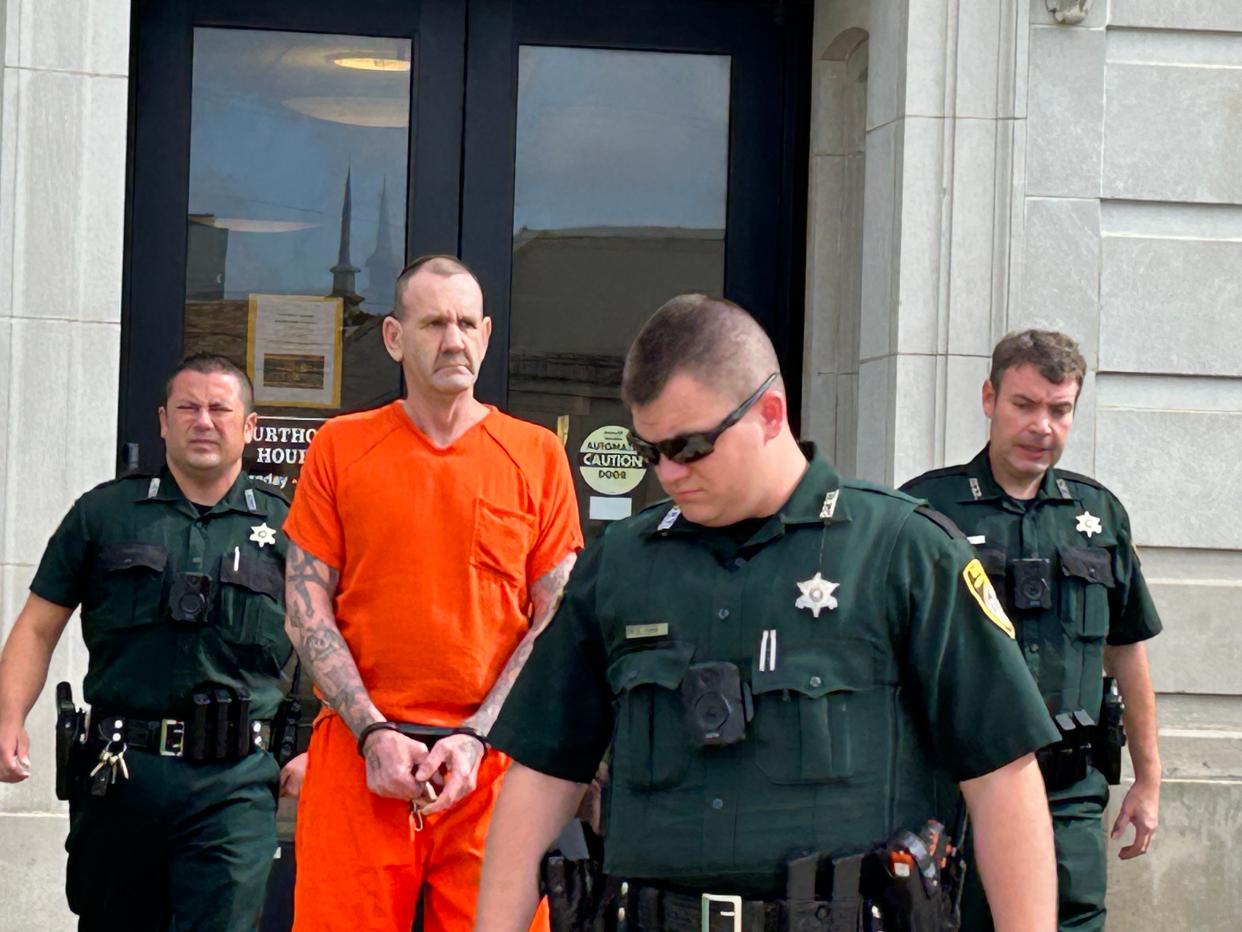 Convicted murderer Larry Doil Sanders, in chains in the middle, is led by Pontotoc County sheriff deputies from the courthouse in Ada Tuesday morning after being sentenced to life in prison without the possibility of parole.