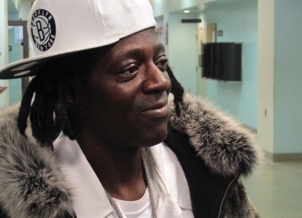 Flavor Flav speaks with reporters following an appearance in Nassau County District Court in Hempstead, N.Y., on Tuesday, Jan. 28, 2014. The rapper, whose real name is William Drayton, was in court on charges he was speeding and driving with a suspended license en route to his mother's funeral in Long Island on Jan. 9. Drayton pleaded not guilty Tuesday and was released without bail. (AP Photo/Frank Eltman)