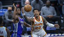 Sacramento Kings forward Harrison Barnes (40) defends against Atlanta Hawks forward John Collins (20) during the first half of an NBA basketball game in Sacramento, Calif., Wednesday, March 24, 2021. (AP Photo/Hector Amezcua)