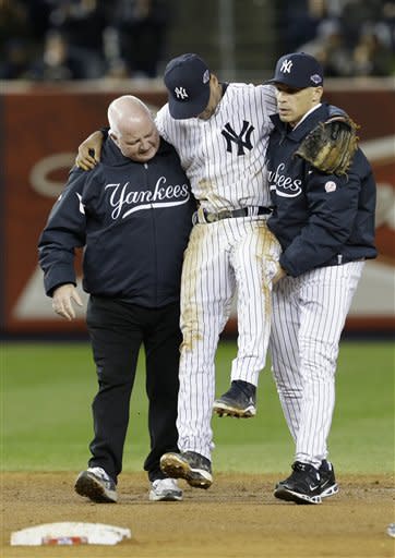 Trainer Steve Donohue, left, and Yankees manager Joe Girardi, help Derek Jeter off the field. (AP)