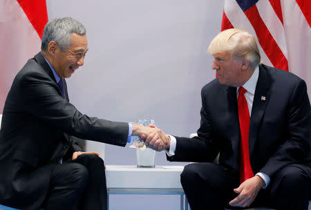 Singapore's Prime Minister Lee Hsien Loong shakes hands with U.S. President Donald Trump during the bilateral meeting st the G20 leaders summit in Hamburg, Germany July 8, 2017. REUTERS/Carlos Barria