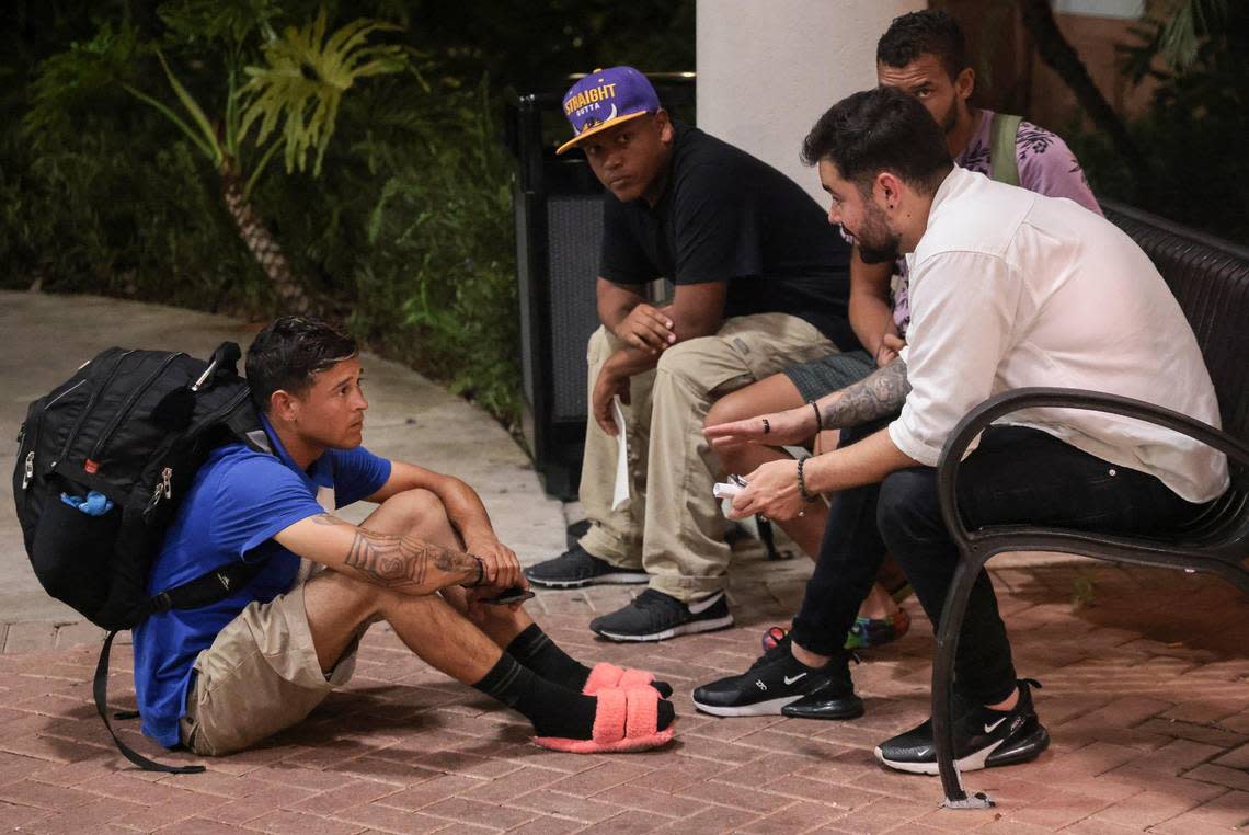 A day after being fired and spending the night outside, Pedro Escalona(left), Jose, and Franklin Pereira beg an Oceanside Labor and Demolition manager (right) to help them cash their checks so that they can return to New York City where they were recruited.