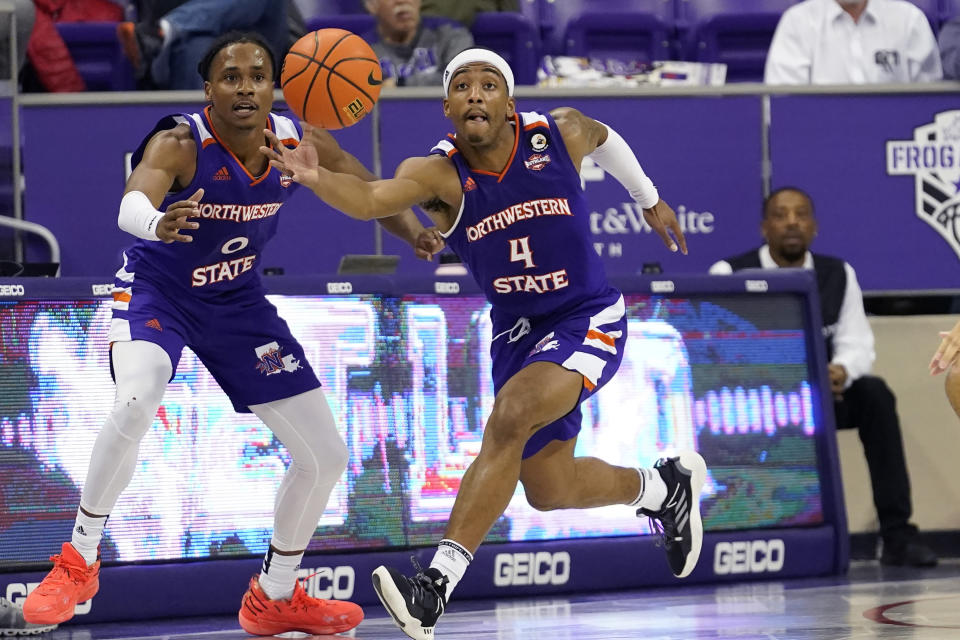 Northwestern State guard JaMonta' Black (4) reaches for the ball in front of teammate Demarcus Sharp (0) during the second half of an NCAA college basketball game against TCU in Fort Worth, Texas, Monday, Nov. 14, 2022. Northwestern State won 64-63. (AP Photo/LM Otero)