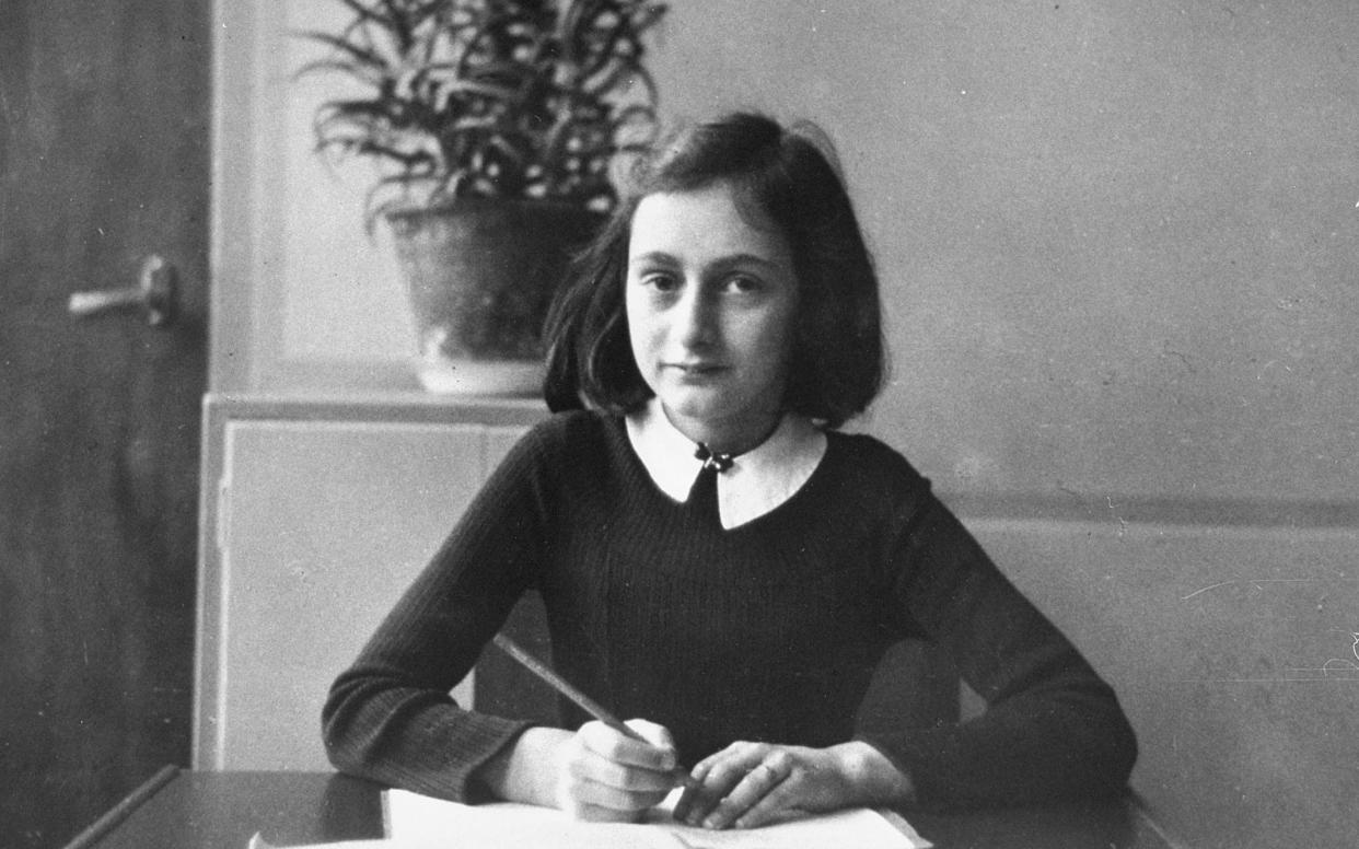 This photo taken in 1940 shows Anne Frank at the age of 12 years, sitting at her desk at the Montessori school in Amsterdam. - Getty Images Fee 