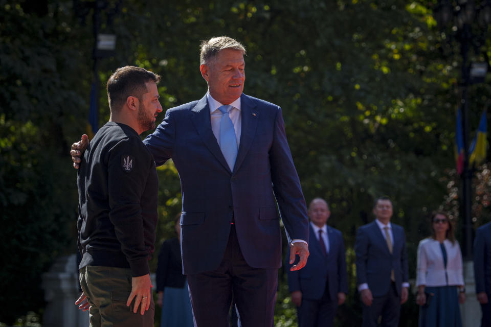 Ukraine's President Volodymyr Zelenskyy, left, walks towards Romanian President Klaus Iohannis at the Cotroceni Presidential Palace in Bucharest, Romania, Tuesday, Oct. 10, 2023. (AP Photo/Andreea Alexandru)