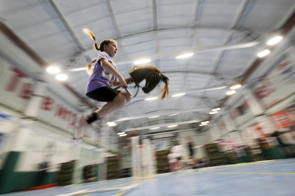 A girl competes during a Hobby horsing competition in St. Petersburg, Russia, on Sunday, April 21, 2024. Several dozen kids, 48 girls and one boy, from first-graders to teenagers gathered in a gymnasium in northern St. Petersburg, Russia's second largest city, for a hobby horsing competition. (AP Photo/Dmitri Lovetsky)