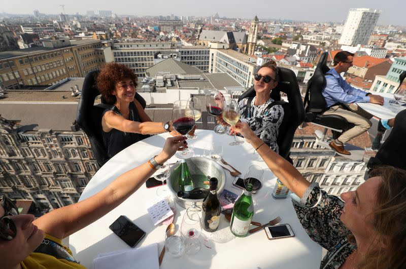 People sit at a table during "Dinner in the Sky 2.0 New Generation” in Brussels