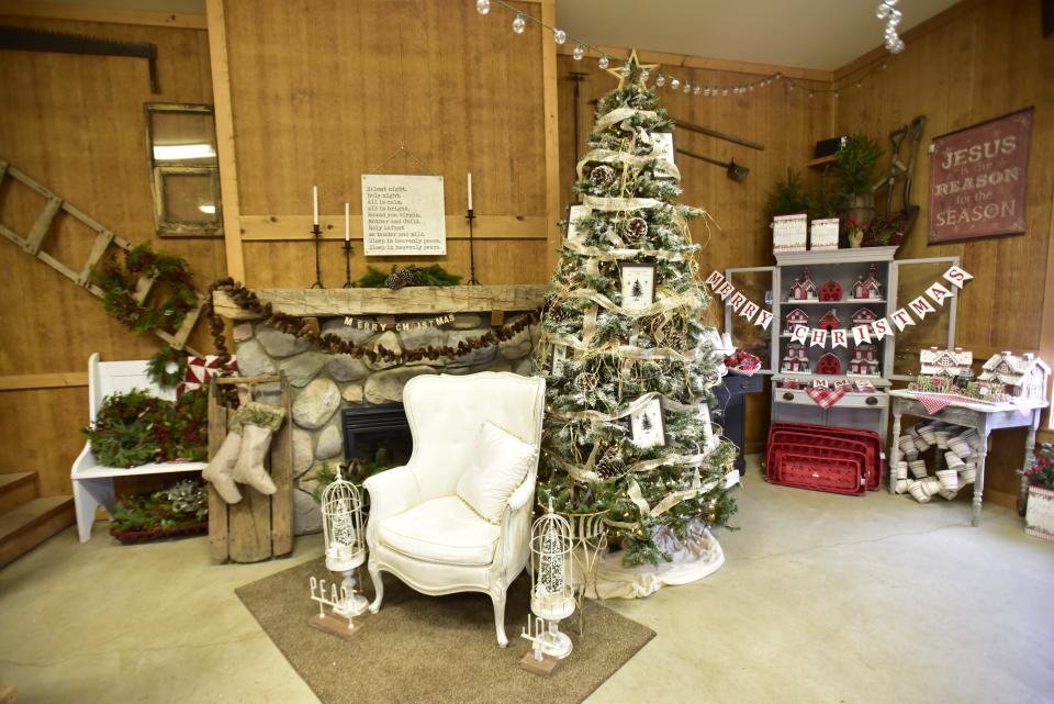 A Christmas tree along with other holiday decorations near a fireplace at Country Christmas Tree Farm located at 8122 Bricker Road in Greenwood Township on Monday, Nov. 14, 2022.