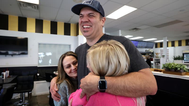 Clint Atwater hugs Catrina Nelson, left, and April Sintz, right, as he gets ready to leave Avenue Bakery in American Fork on Monday, March 20, 2023. They became friends trying to help alleviate their children’s seizures. Nelson’s daughter Charlee died just days after Charlee’s Law was passed in her name, allowing medical cannabis use in Utah. Atwater’s daughter experienced a drastic reduction of seizures while using cannabis before she died last year. Sintz’s son currently uses cannabidiol to treat his seizures.