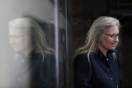 U.S. photographer Annie Leibovitz is reflected in glass during a press preview of her exhibition 'WOMEN: New Portraits' at Wapping Hydraulic Power Station in London, Britain January 13, 2016. REUTERS/Stefan Wermuth