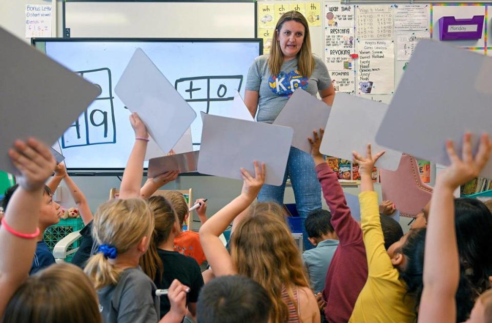Students raise their wipe boards with their math equation written on it for first grade teacher Mary Krejci on May 10, 2023, at Piper Prairie Elementary School in Kansas City, Kansas. Krejci was announced as the winner of the Kansas City Star’s Honor Roll teacher poll.